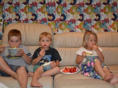 Yes the kids are eating on the couch, yes Melia is eating with her fingers with her eyes closed, Yes they are watching TV, that's how we roll . . .