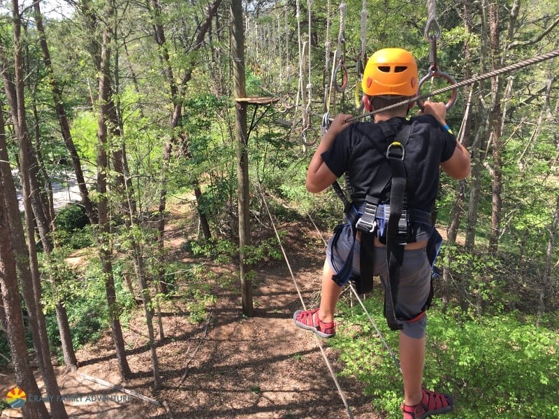 Carson navigating the ropes course in Asheville, NC