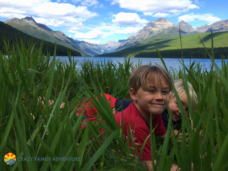 Playing in the grass at Bowman Lake