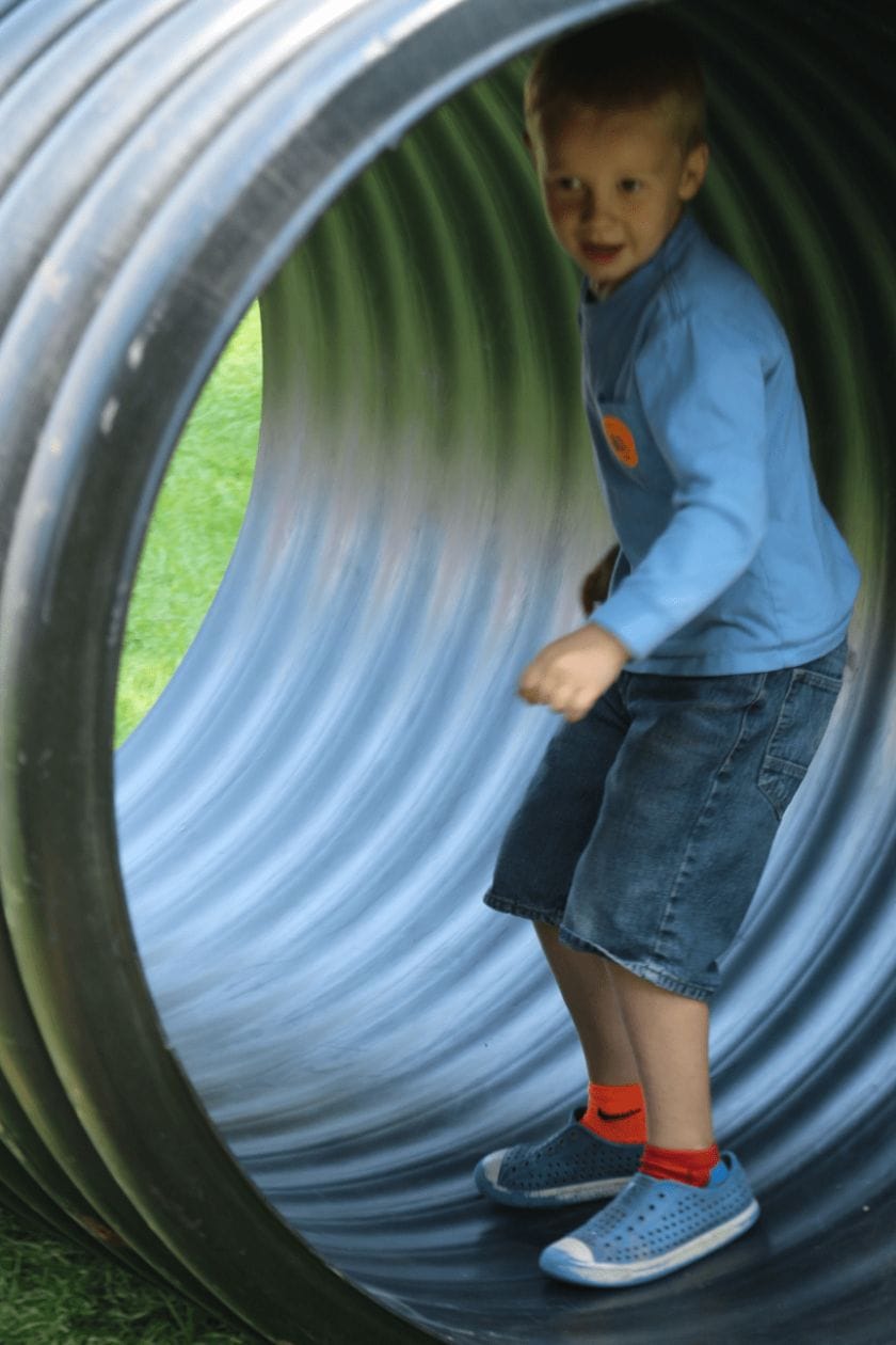 Kid in a play tube at Green Meadows Farm