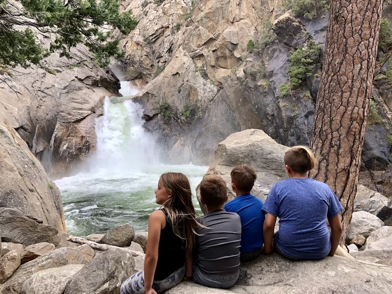 The kids are taking in the beauty of Roaring River Falls in King's Canyon National Park near Sequoia National Park