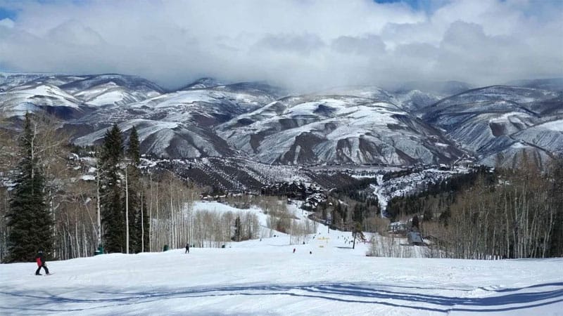 view of the ski trails with the mountains in the background, one of the best family ski resorts in Colorado