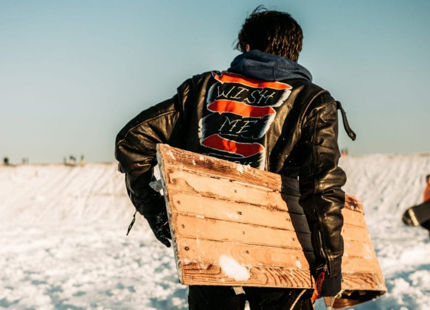 Picture of a man carrying a sled, Sledding in Wisconsin