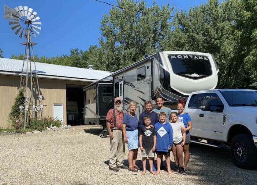 Family standing in front of an RV, Boondocks Welcome