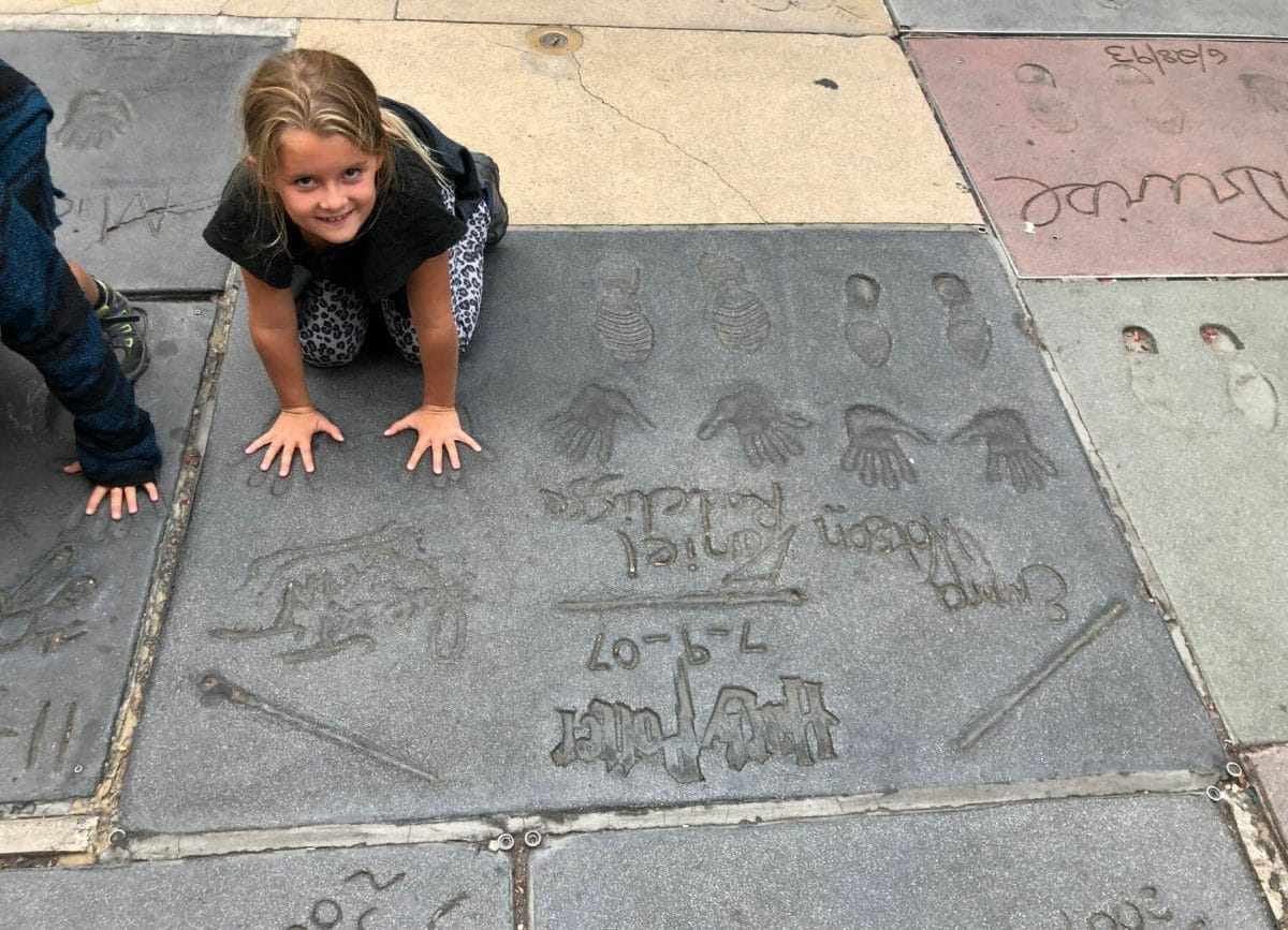 Child with her hands on the Hollywood Walk of Fame, Day trips from San Diego