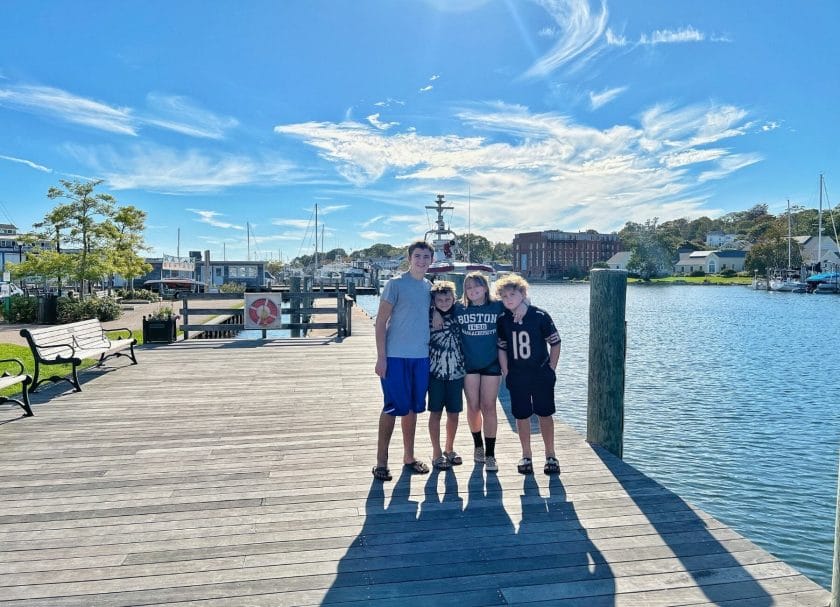 shows 4 kids standing on a pier in downtown mystic, East coast road trip