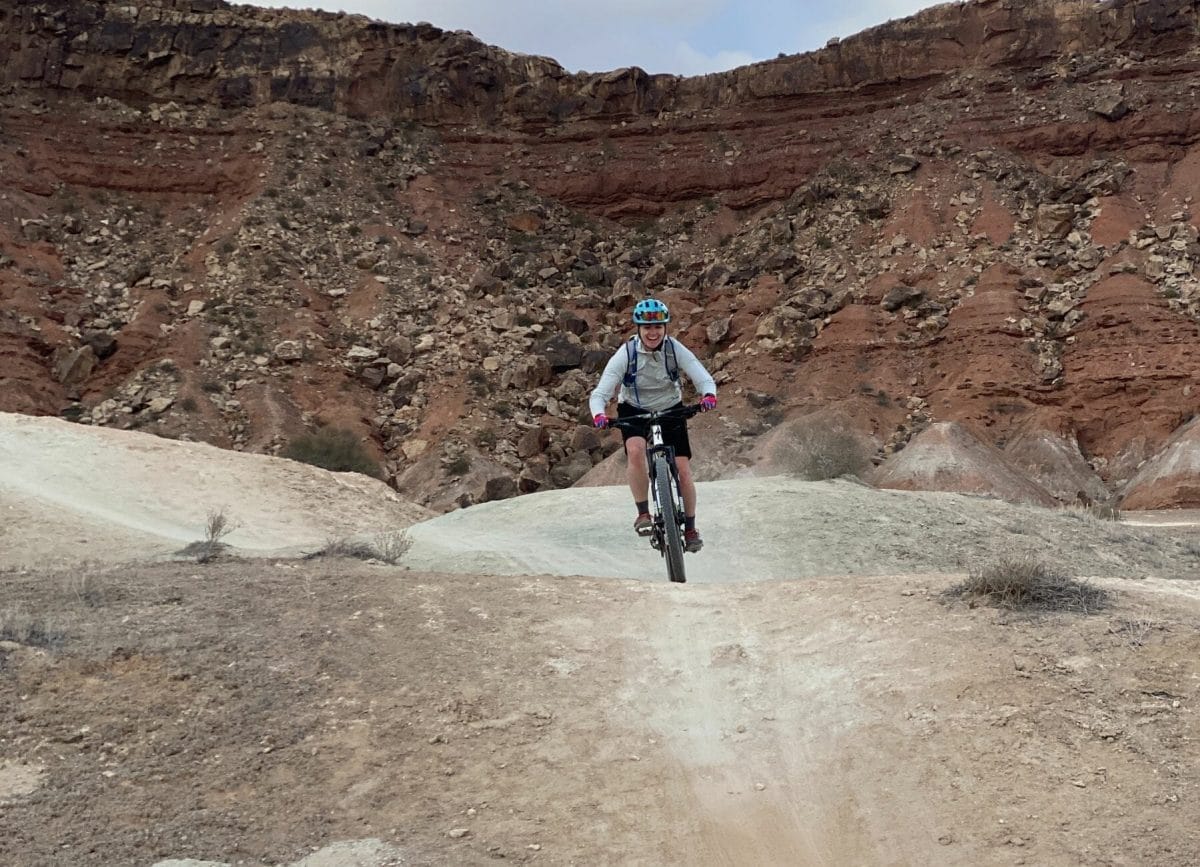 A woman riding a bike at White Rim Utah Mountain Biking