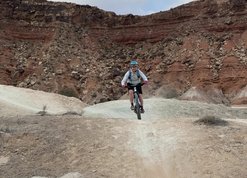 A woman riding a bike at White Rim Utah Mountain Biking