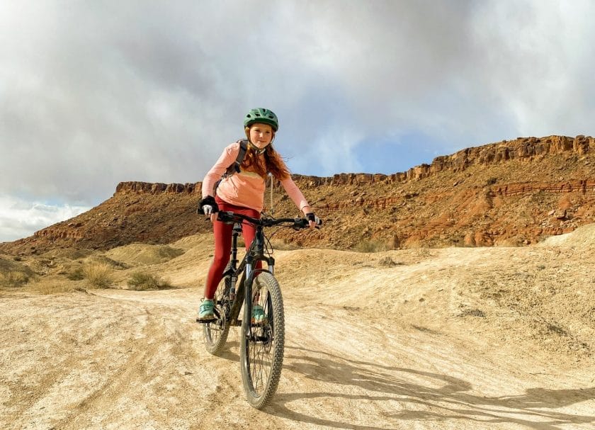 A girl riding a bike at Whole Enchilada Utah Mountain Biking