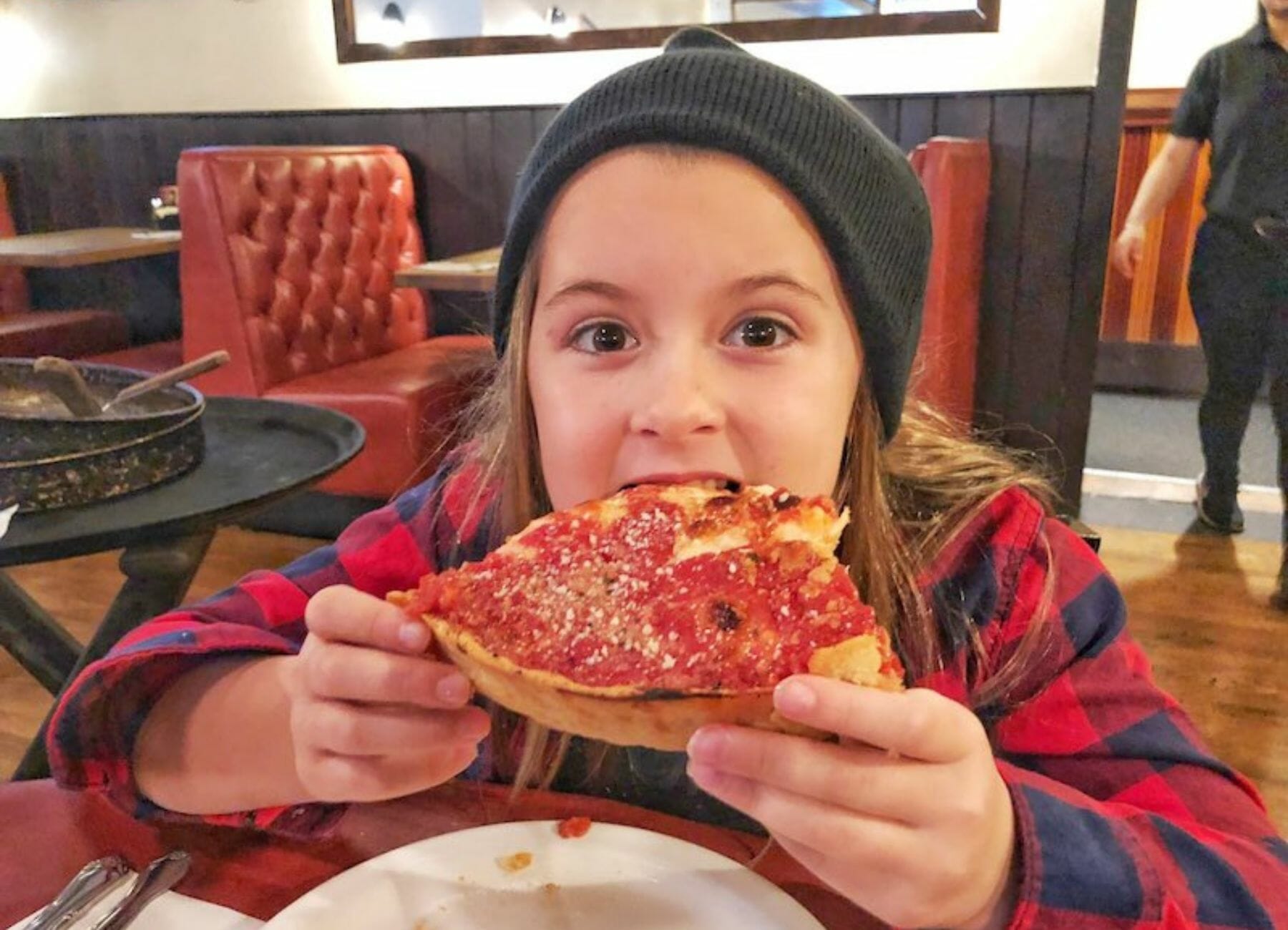 Enjoying pizza on the best in chow food tour, things to do in Chicago