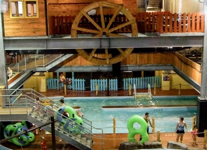 Shows a downward view of a family with inner tubes outside of the indoor pool, indoor water parks in Michigan
