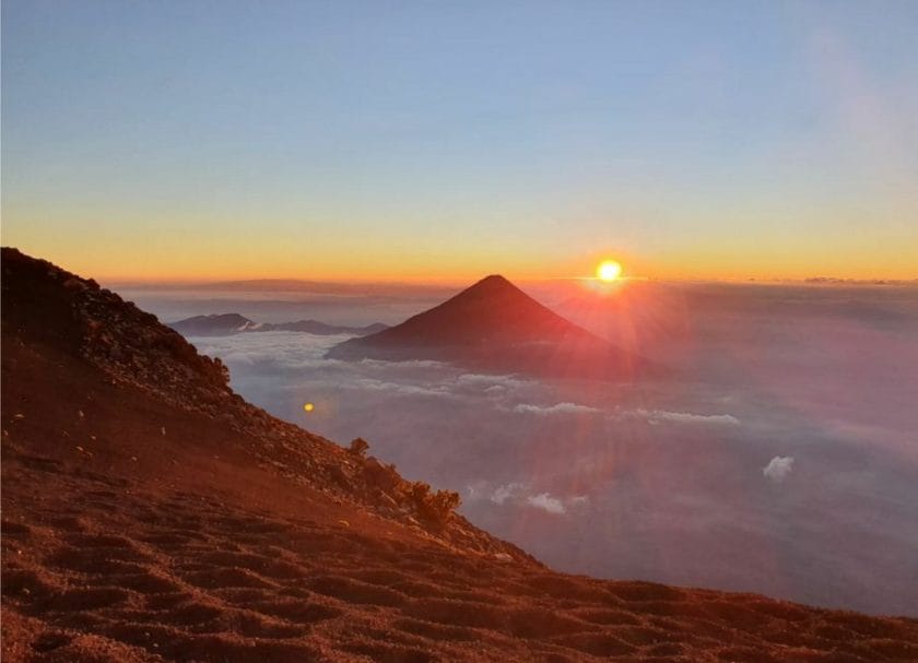 View of a sunset from above the clouds on Acatenango Volcano, things to do in Guatemala.