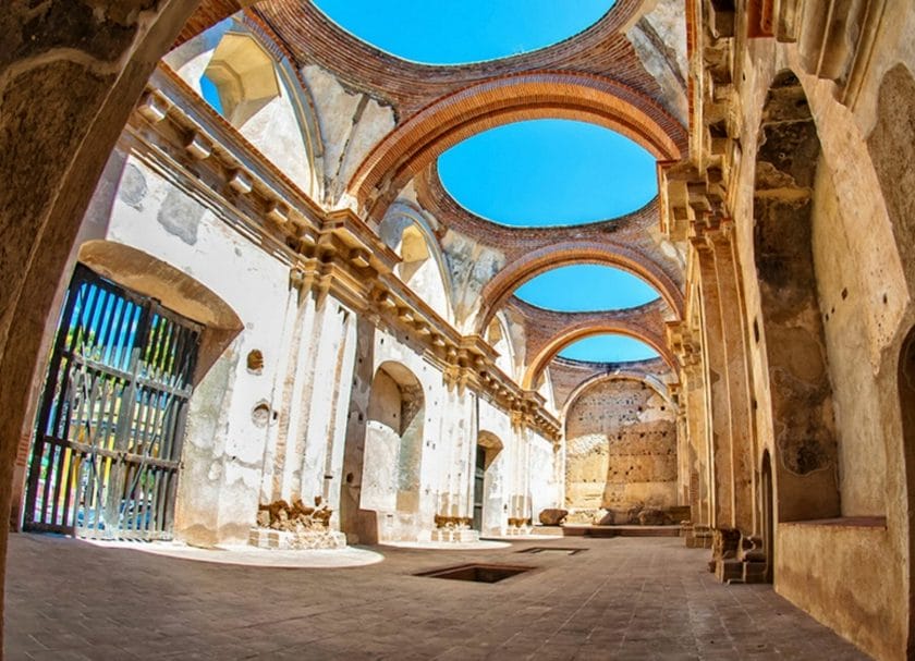 Shows blue sky and sunshine shining down through the roof at Cathedral San Jose in Antigua, Things to do in Antigua Guatemala