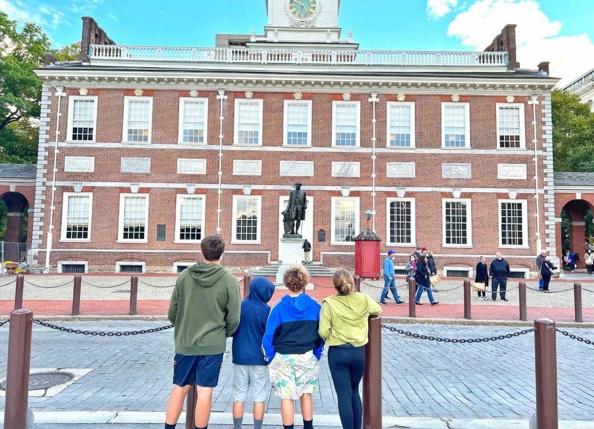 Shows 4 kids standing in front on Independence Hall in Philadelphia Pennsylvania Fun things to do in Philadelphia with kids