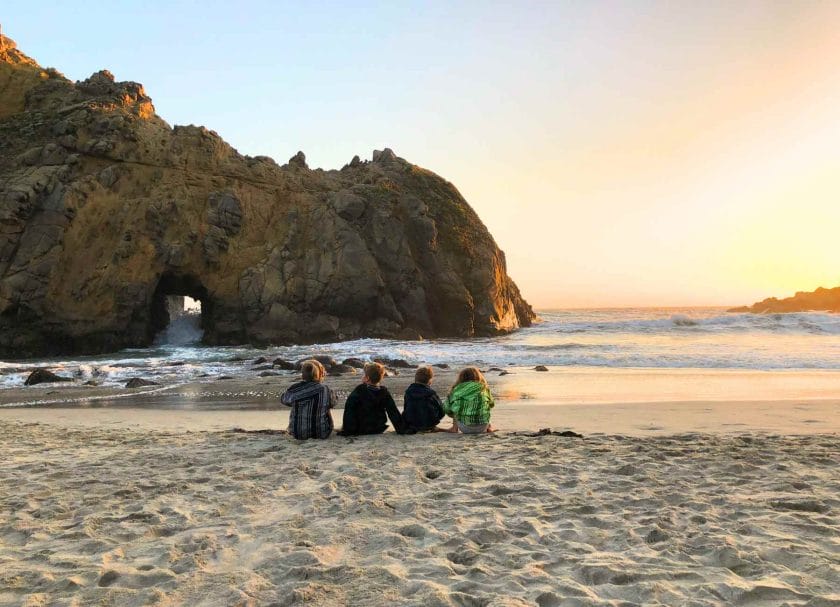 Kids sitting and watching the sunset at Pfeiffer Beach