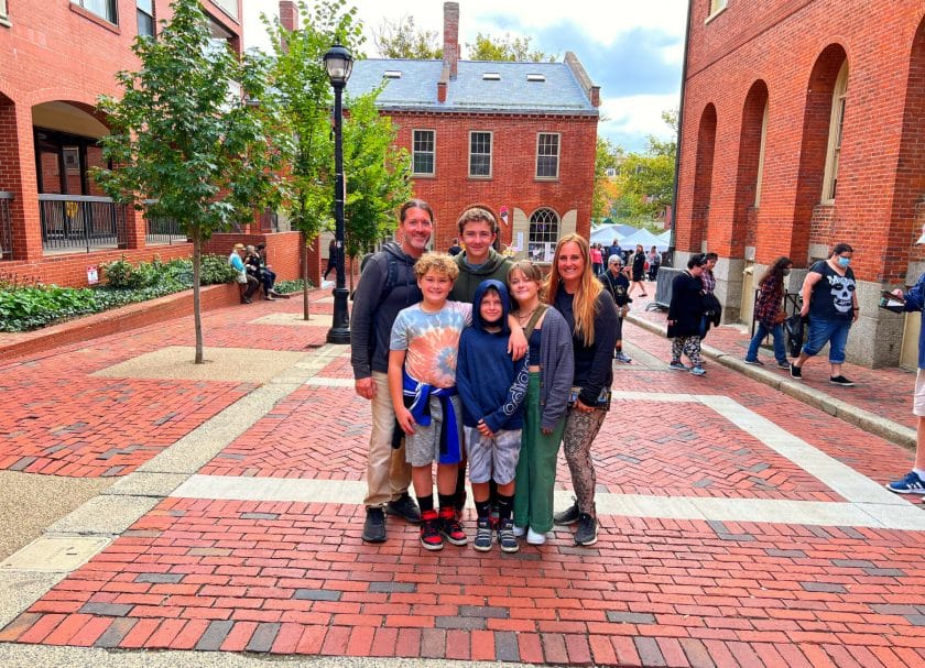 Picture of a family posing for a photo on the streets of Salem, MA, Things to do in Boston with Kids
