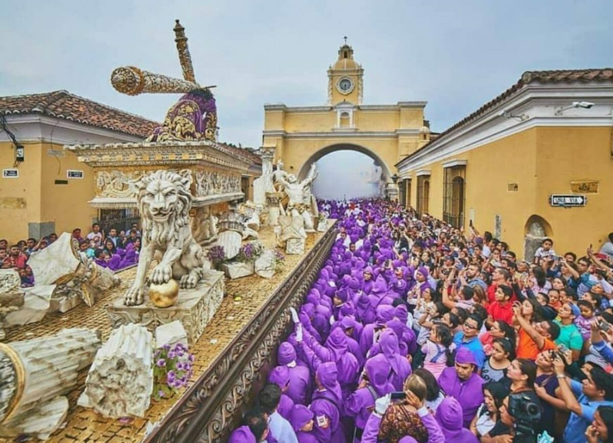 Shows the processions during Holy Week with crowds of people watching, things to do in Antigua, Guatemala