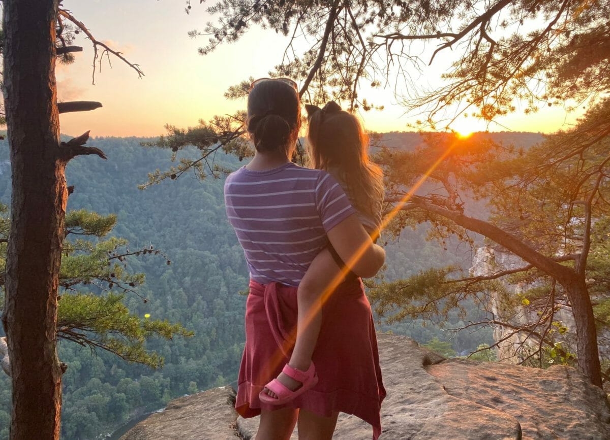 A mother and daughter looking at the sunset at Diamond Point Overlook, Things to do in New River Gorge National Park.