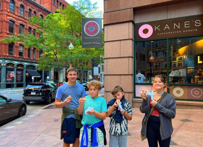 Picture of 4 kids enjoying donuts while on the Underground Donut Tour, Things to do in Boston with Kids.