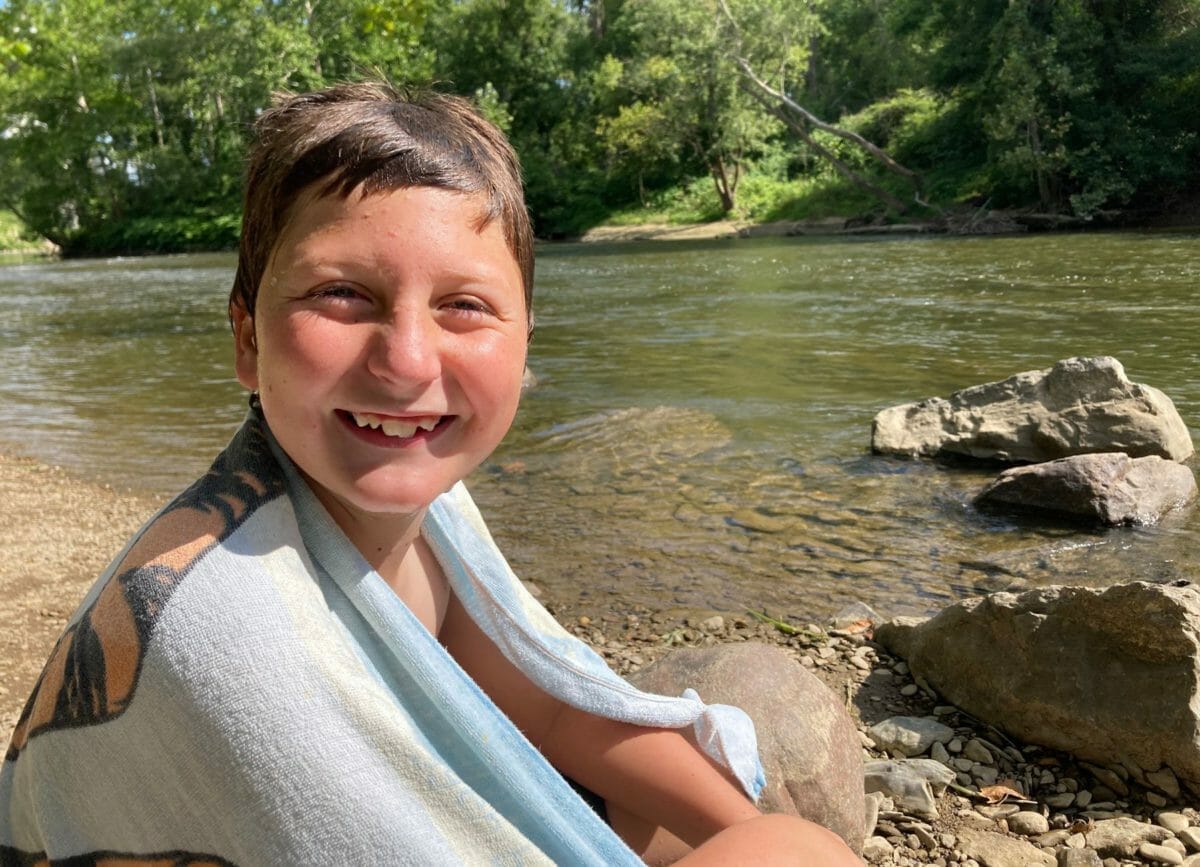 Picture of a boy smiling after swimming in the Cuyahoga River, Things to do in Cuyahoga Valley National Park.
