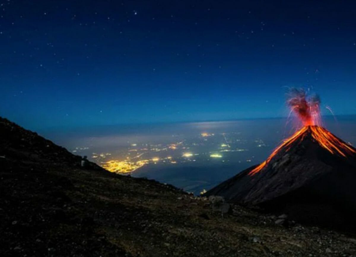 View of the active Fuego Volcano from Volcano Pacaya at night, you can see the lava flowing, Things to do in Antigua Guatemala