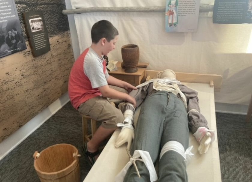Shows a child learning about medical care at the Children of Gettysburg 1863 museum, Things to do in Gettysburg