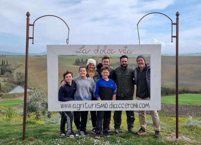 Picture of the family holding a sign for agriturismo Diaccenroni, Things to do in Tuscany
