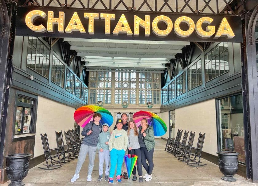 Family picture under the Chattanooga sign at the Chattanooga Cho Cho.
