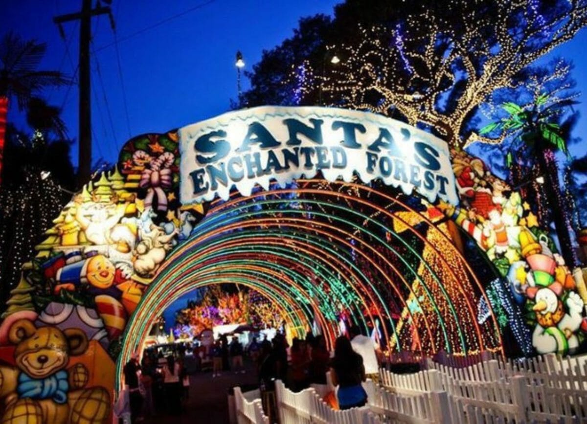 Shows the lit entrance of Santa's Enchanted Village