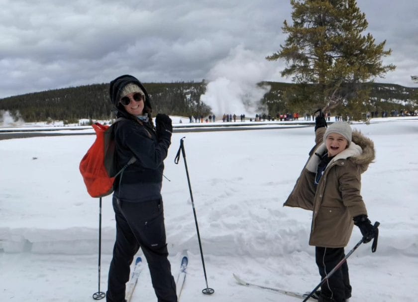 Skiing with Old Faithful erupting in the background, Yellowstone in Winter