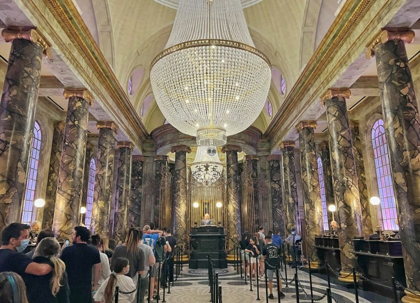 Shows the inside of Gringott's Bank including the chandelier and head goblin, Harry Potter World Rides