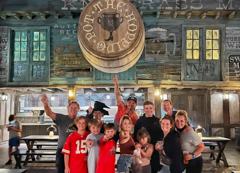 Picture of the family in front of The Hopping Pot, standing under a barrel of Butter Beer, Harry Potter World Rides