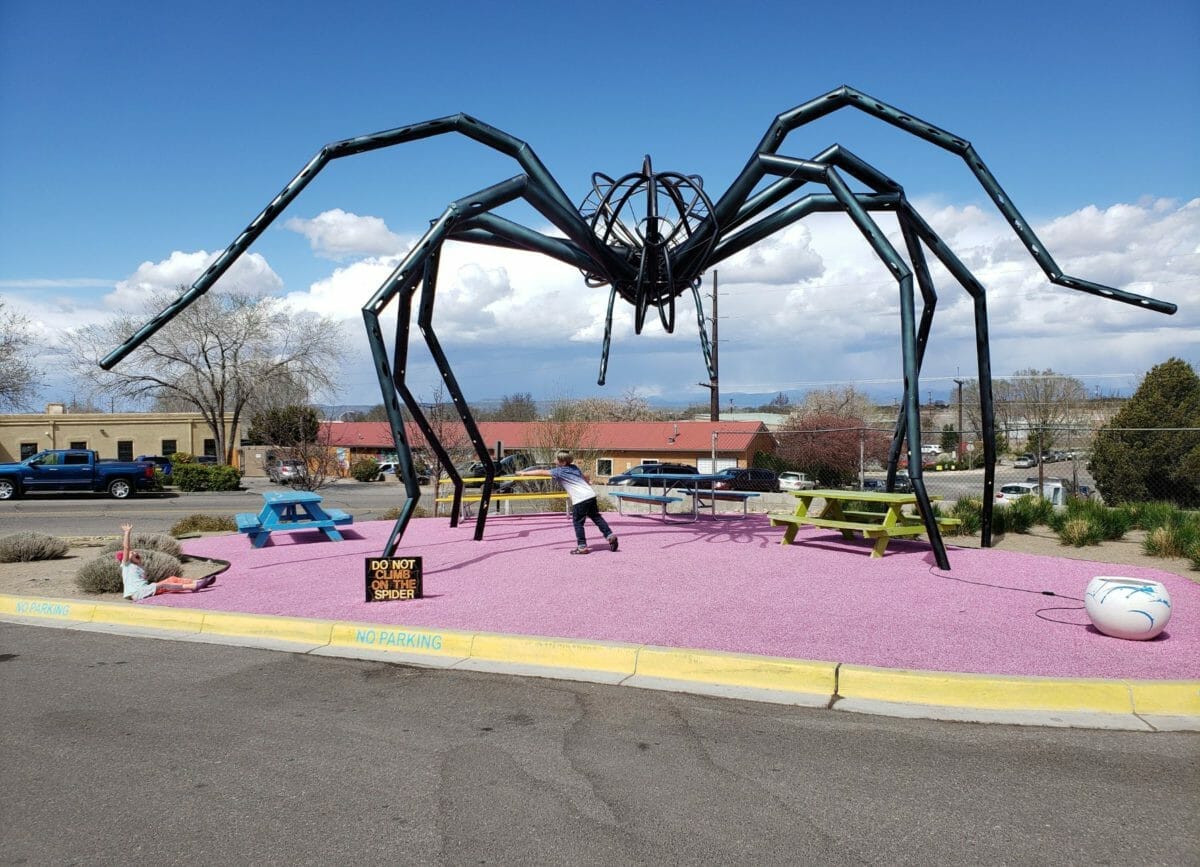 Shows an outdoor art installation of a metal spider at Meow Wolf Santa Fe, Meow Wolf Review