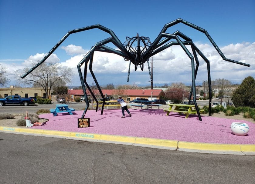 Shows an outdoor art installation of a metal spider at Meow Wolf Santa Fe, Meow Wolf Review