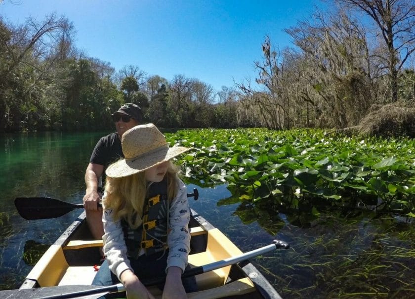 Man and girl in canoe at Silver Springs Best springs in Florida