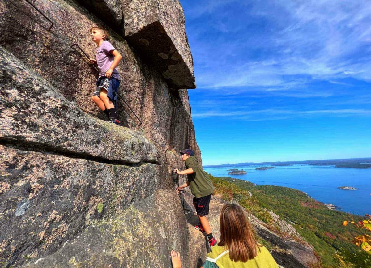 3 kids climbing up Precipice Trail at Acadia National Park