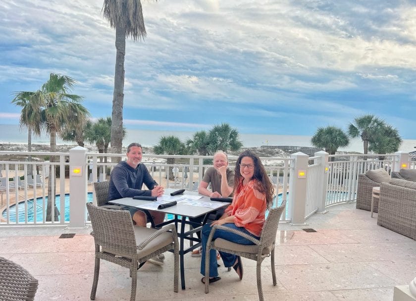 Sitting at the table overlooking the pool at the Coast Restaurant and Gulf-Front Veranda