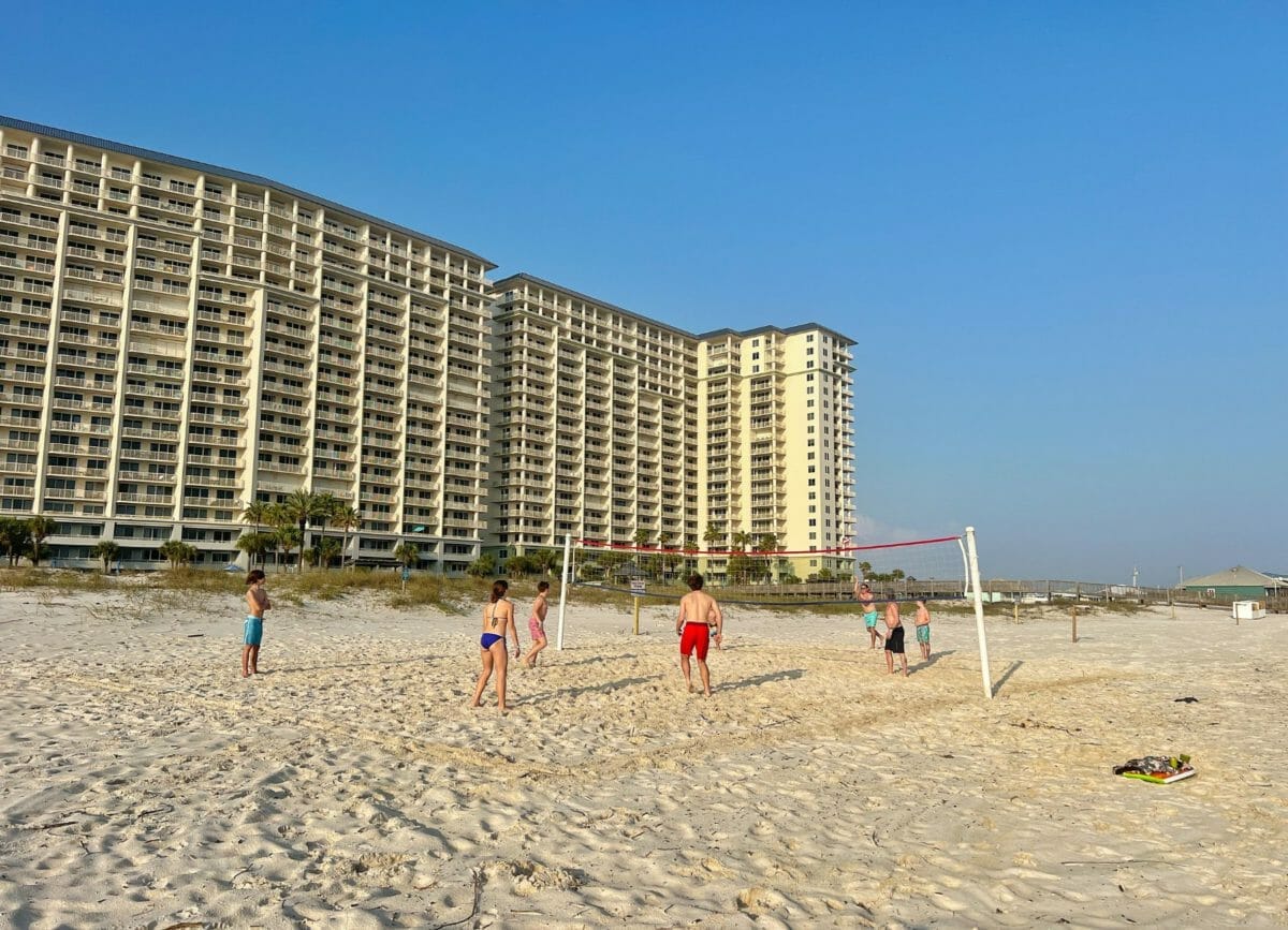 Playing volleyball at the beach by the resort.