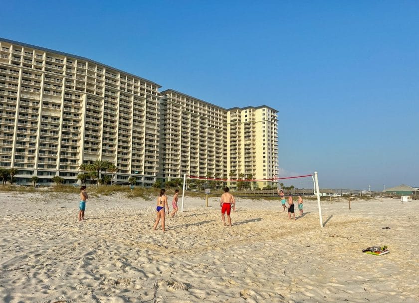 Playing volleyball at the beach by the resort. 