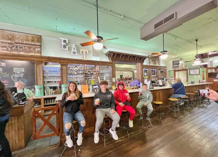 Kids sitting at the soda bar in A Schwab on Beale Street. A top things to do in Memphis with kids!