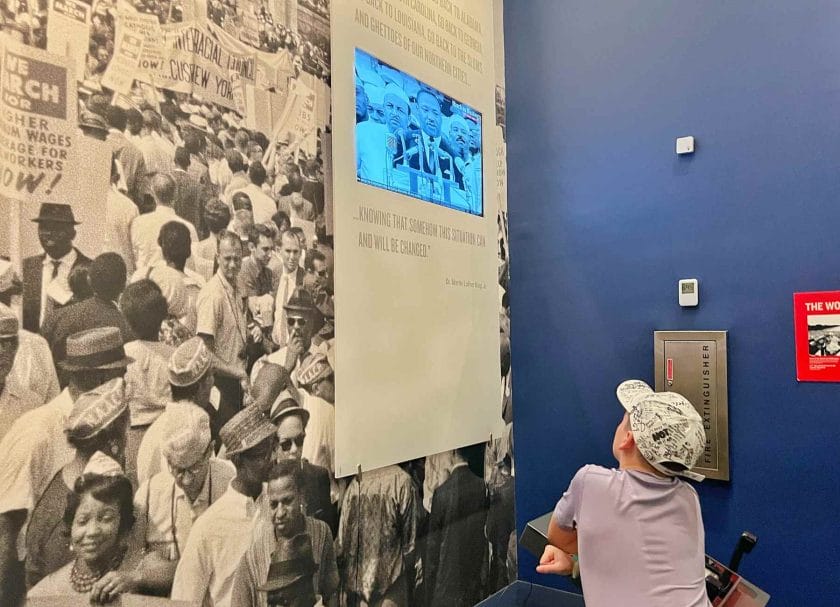 Knox watching the Martin Luther King Jr I Have A Dream Speech on a TV at the Civil Rights Museum - a top thing to do in Memphis Tennessee.