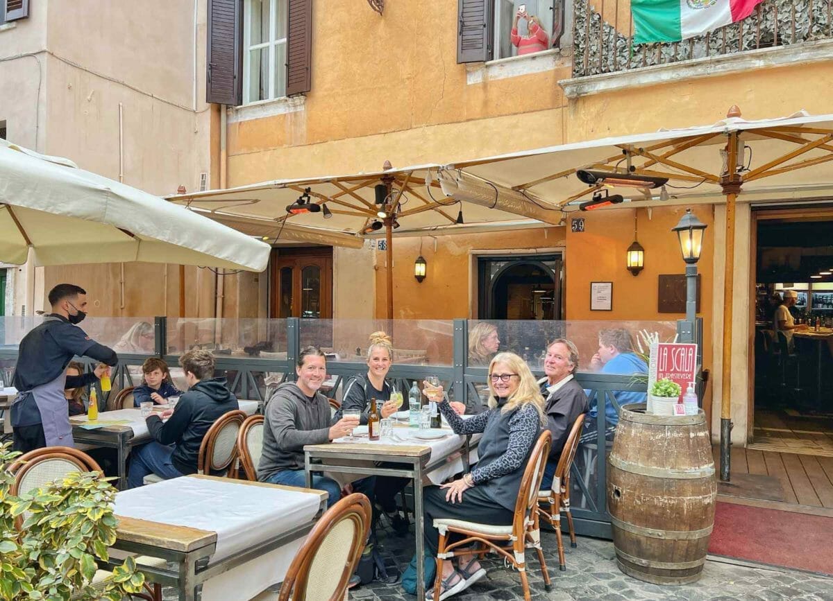 Us sitting at a table with my parents getting a drink in the Trastevere neighborhood in Rome.