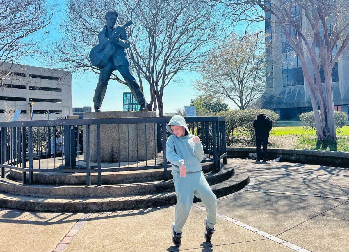 Knox striking a pose by the Elvis statue.