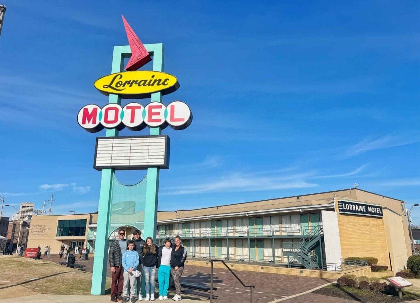 Our family standing by the Lorraine Motel sign. A top thing to do in Memphis Tennessee.