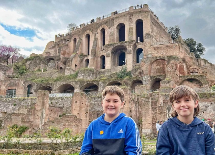 Cannon and Knox sitting in front of a building in the Roman Forum. 