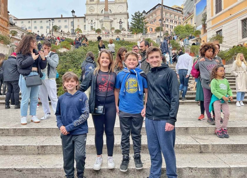 The kids standing in front of the Spanish Steps. 