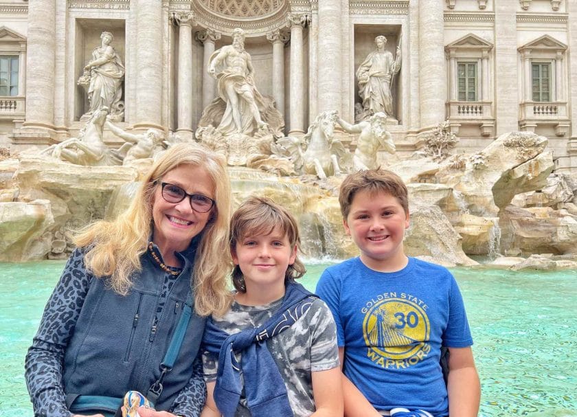 Nana, Knox and Cannon sitting in front of the Trevi Fountain. 