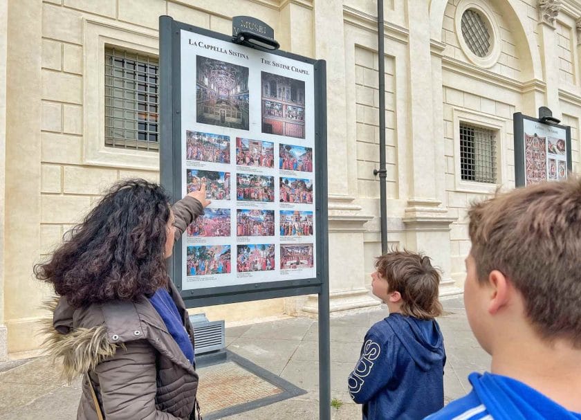 Our tour guide at the Vatican showing Knox a picture. 