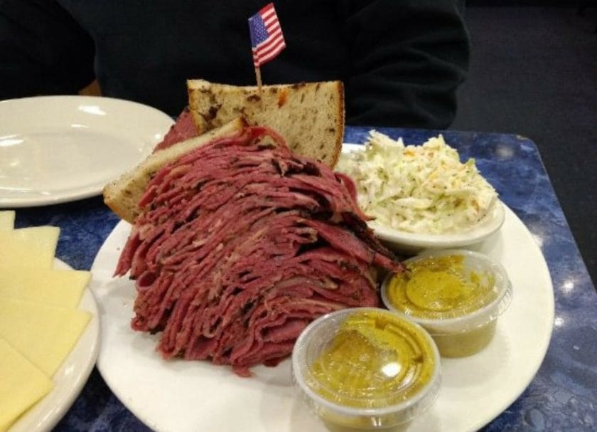 Shows a large pastrami sandwich served on a plate from Harold's New York Deli, things to do in New Jersey