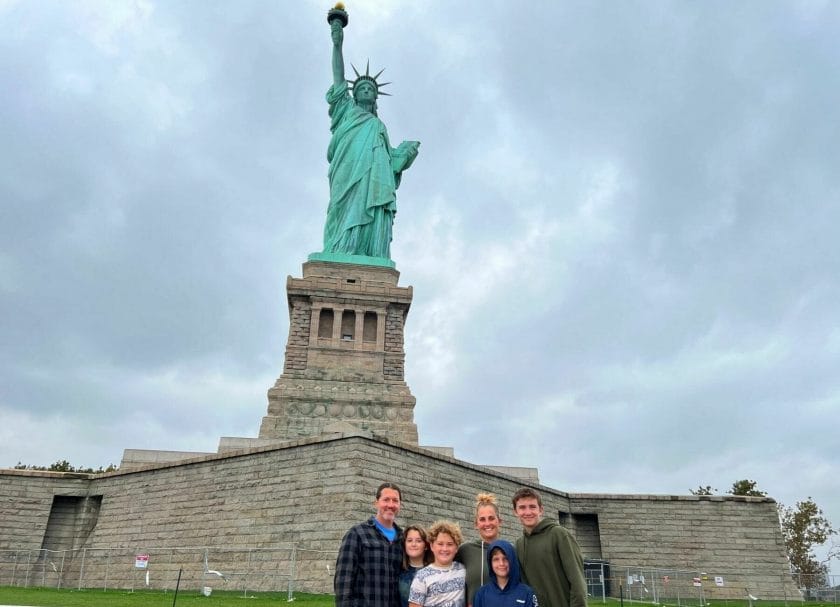 Shows a family standing in front of the Statue of Liberty, Things to do in New Jersey